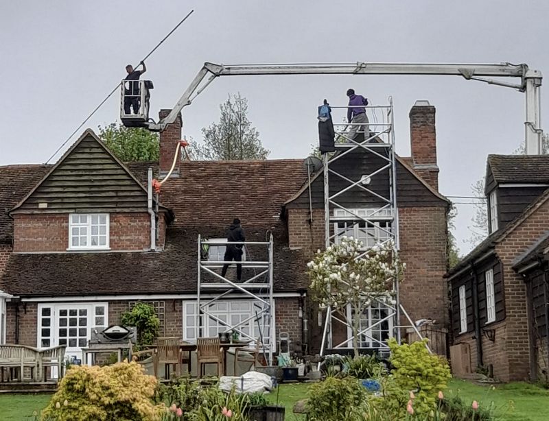 The Moss Cleaners using cherry picker and scaffolding to clean roof safely and professionally in Beckenham, London